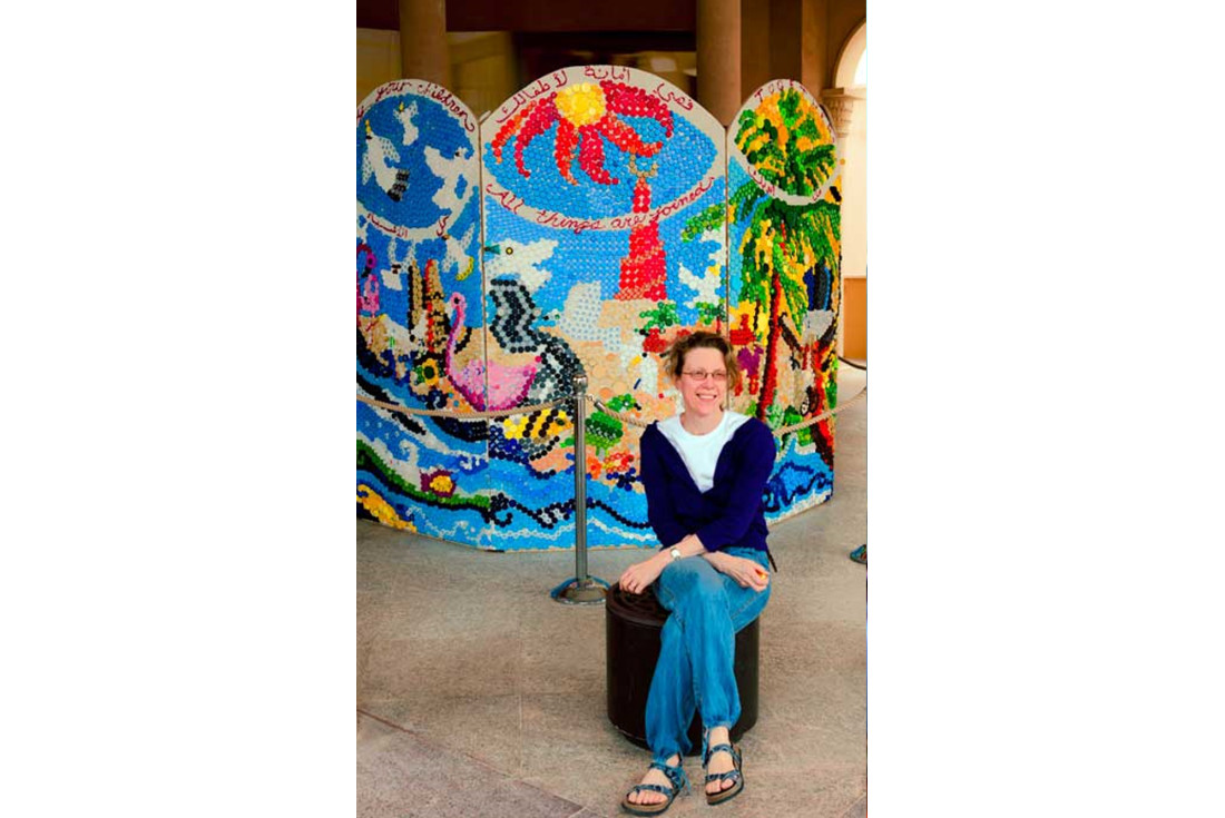 Sarah with the artwork created from bottle caps